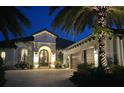 Luxury home exterior at night with lighting at 15908 Castle Park Ter, Lakewood Ranch, FL 34202