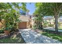 Two story townhome with lush landscaping and a paved driveway at 7216 Sterling Point Ct, Gibsonton, FL 33534