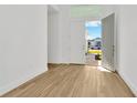 Bright entryway with open doors and light wood flooring at 8328 Golden Beach Ct, Parrish, FL 34219