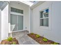 House entrance with double gray doors and a brick walkway at 8328 Golden Beach Ct, Parrish, FL 34219