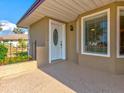 Front porch with white door and window at 1810 Haverford Ave, Sun City Center, FL 33573