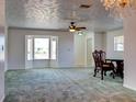 Spacious living room with carpeted floor and bay window at 1810 Haverford Ave, Sun City Center, FL 33573