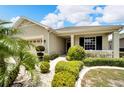 House exterior with a paved walkway and manicured landscaping at 1013 Emerald Dunes Dr, Sun City Center, FL 33573