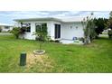 Ranch-style home with a patio and lawn at 10032 36Th N St, Pinellas Park, FL 33782