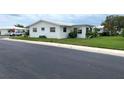 Ranch-style home with a side view and lawn at 10032 36Th N St, Pinellas Park, FL 33782