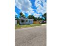 Blue house with a fenced yard and covered front porch at 1703 Mobile Ave, Tampa, FL 33610