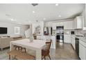 Bright kitchen with stainless steel appliances and an island at 10619 Hidden Banks Gln, Parrish, FL 34219