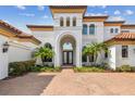 Grand entrance of luxury home with brick driveway and Mediterranean style at 12310 Stonelake Ranch Blvd, Thonotosassa, FL 33592