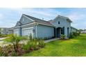 Light blue home with two-car garage and walkway at 12706 Palatka Dr, Venice, FL 34293