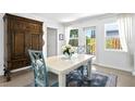 Bright dining area with white table, blue chairs, and large wooden cabinet at 401 Appian Ne Way, St Petersburg, FL 33704