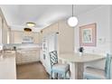 Well-equipped kitchen with white cabinets, stainless steel appliances, and breakfast bar at 401 Appian Ne Way, St Petersburg, FL 33704