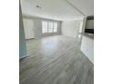 Spacious living room with wood-look floors and neutral walls at 8353 Normandy Dr, Weeki Wachee, FL 34613