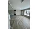 Open living room with gray wood-look flooring at 8353 Normandy Dr, Weeki Wachee, FL 34613