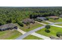 Aerial view of house and property, wooded area nearby at 6218 Bridleford Dr, Wesley Chapel, FL 33545