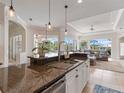 Open concept kitchen with granite countertops, stainless steel appliances, and ample cabinet space at 33724 Americana Ave, Dade City, FL 33525