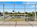 View from covered patio overlooking canal, boats, and other homes at 5243 Wishing Arch Dr, Apollo Beach, FL 33572