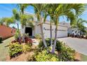 Two-story house with white exterior and landscaping at 5243 Wishing Arch Dr, Apollo Beach, FL 33572