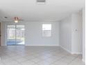 Living room with tile flooring and sliding glass doors at 3818 Darlington Rd, Holiday, FL 34691