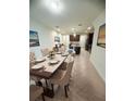 Inviting dining area showcasing a large table with seating for six and seamless flow into the kitchen at 11522 Cambium Crown Dr, Riverview, FL 33569