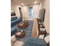 Bright living room featuring modern decor, plush seating, and a stylish blue rug at 11522 Cambium Crown Dr, Riverview, FL 33569