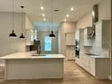 Bright kitchen with island, stainless steel appliances, and pendant lighting at 13530 Oldenburg Dr, Hudson, FL 34667