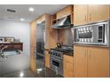 Stainless steel appliances and light wood cabinets in this modern kitchen at 1120 E Kennedy Blvd # 827, Tampa, FL 33602