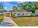 Tan single story house with landscaping and driveway at 6921 Onyx N Dr, St Petersburg, FL 33702