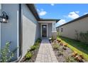 Charming home featuring a stone-accented entry with manicured landscaping and a welcoming front door at 3778 Maxwell Park Dr, Sun City Center, FL 33573