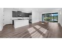 Modern kitchen with stainless steel appliances, white countertops, and sleek dark cabinetry at 3778 Maxwell Park Dr, Sun City Center, FL 33573