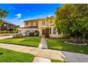 Two story yellow brick home with manicured lawn at 803 Bayshore Blvd, Tampa, FL 33606