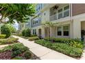 Townhome community with landscaped walkway and lush greenery at 9589 Cavendish Dr, Tampa, FL 33626