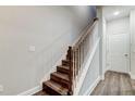 Modern staircase with dark wood treads and white railing at 9589 Cavendish Dr, Tampa, FL 33626