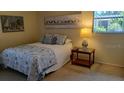 Bright bedroom with double bed and nightstand at 6263 Green View Cir # 107, Sarasota, FL 34231