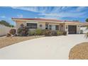 Charming single-story home featuring a terracotta roof and a spacious driveway with low maintenance landscaping at 186 45Th Ave, St Pete Beach, FL 33706