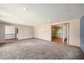 Spacious living room with plush carpeting, recessed lighting, and an open layout for comfortable living at 2115 Seagull Dr, Clearwater, FL 33764