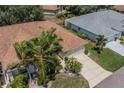 Aerial view of single-story house with brown roof and lush landscaping at 912 Oxford Park Dr, Sun City Center, FL 33573