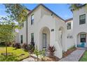 Charming two-story home featuring a stucco facade, arched entryway, and lush landscaping at 4606 W Fig St # 4, Tampa, FL 33609
