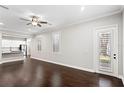 Inviting living room featuring hardwood floors, a stylish entertainment center, and a view into the modern kitchen at 4606 W Fig St # 4, Tampa, FL 33609