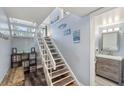 Staircase leading to upper level, with storage and a view of a bathroom at 5030 N Beach Rd # 2, Englewood, FL 34223