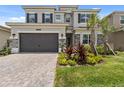 Two-story home with a two-car garage and attractive landscaping at 32588 Tree Of Life Ave, Wesley Chapel, FL 33543