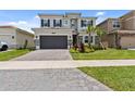 Two-story home with a two-car garage and well-maintained lawn at 32588 Tree Of Life Ave, Wesley Chapel, FL 33543