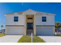 Two story house with double garage and front porch at 3431 Sheephead Dr, Hernando Beach, FL 34607