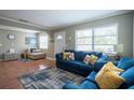 Spacious living room featuring two blue sofas and a patterned rug at 803 Marshall St, Clearwater, FL 33755