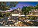 Two-story home with gray exterior, attached garage, and landscaped yard at 5224 Mango Fruit St, Seffner, FL 33584