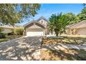 Two-story home with gray exterior, attached garage, and landscaped yard at 5224 Mango Fruit St, Seffner, FL 33584