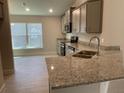Modern kitchen with granite countertops and stainless steel appliances at 36188 Welsh Glade Rd, Dade City, FL 33525