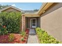 Inviting front entrance with a well-maintained walkway and colorful landscaping at 3554 Deer Run S, Palm Harbor, FL 34684