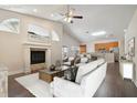 Spacious living room featuring vaulted ceilings, a fireplace, and hardwood flooring at 3554 Deer Run S, Palm Harbor, FL 34684