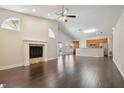 Open living room with hardwood floors, fireplace, and kitchen views at 3554 Deer Run S, Palm Harbor, FL 34684