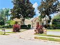 Beautiful one story home showcasing lush landscaping and a brick paved driveway at 1227 Toscano Dr, Trinity, FL 34655